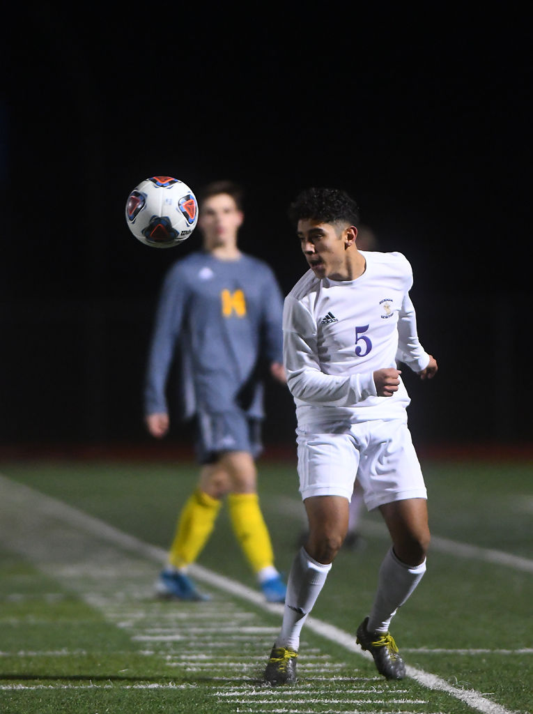 Nick Lugo makes a header to keep the ball in play during their playoff match